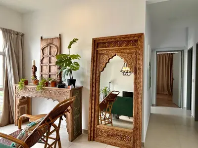 an ornate mirror in a room with a chair at 3BR Vintage design Level 26, KL Sentral City View in Kuala Lumpur