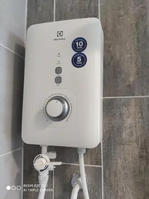 a white soap dispenser on a wall in a bathroom at Best & Affordable KL Arte Plus 2 bedroom Homestay in Kuala Lumpur