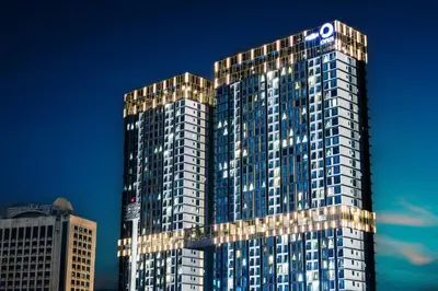 a tall building with a sign on top of it at Luxe Suite in Kuala Lumpur