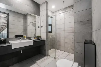 a bathroom with a toilet and a sink and a shower at Luxe Suite in Kuala Lumpur