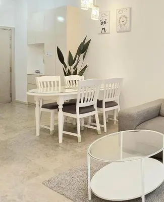 a living room with a table and chairs and a couch at Bukit Bintang Fairlane Residence Pavilion KLCC #A25 in Kuala Lumpur