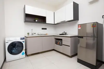 a kitchen with a refrigerator and a washer and dryer at KL Panorama in Kuala Lumpur
