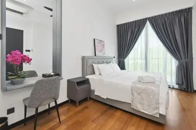 a bedroom with a white bed and a window at KL Panorama in Kuala Lumpur