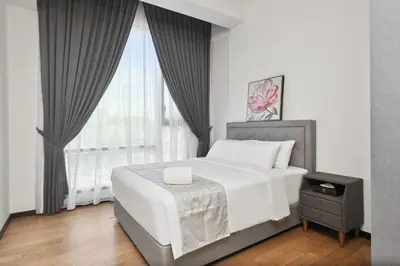 a bedroom with a white bed and a window at KL Panorama in Kuala Lumpur