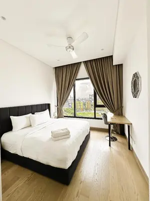 a bedroom with a large bed and a window at Lucentia Global Luxe Suites Kuala Lumpur in Kuala Lumpur