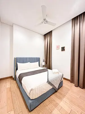 a bedroom with a bed and a ceiling fan at Lucentia Global Luxe Suites Kuala Lumpur in Kuala Lumpur