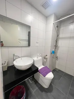 a bathroom with a sink and a toilet and a mirror at Serenity Stay in Chambers Residence in Kuala Lumpur