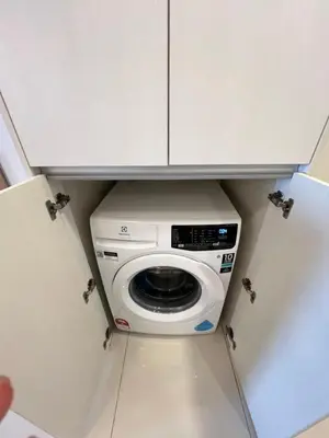 a washer and dryer in a small kitchen at Serenity Stay in Chambers Residence in Kuala Lumpur