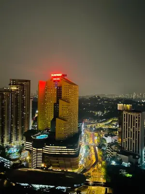 a lit up building in a city at night at Serenity Stay in Chambers Residence in Kuala Lumpur