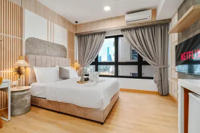 a bedroom with a bed and a large window at Woody Studio Agile Bukit Bintang by RumaBnB in Kuala Lumpur