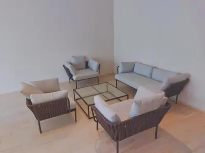 a living room with chairs and a couch and a table at Eaton Residence KLCC Elite Suites in Kuala Lumpur