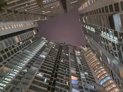 a view of two tall buildings at night at Regalia Suites Best Couples Studio KLCC in Kuala Lumpur