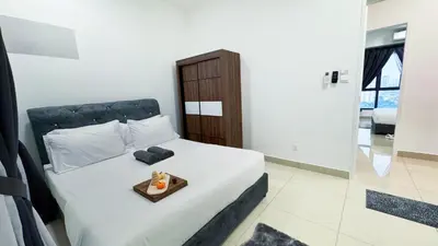 a bedroom with a bed with a tray on it at Vista Sentul Residences, 3-Bedroom Fully Air-Con Suite, SENTUL in Kuala Lumpur