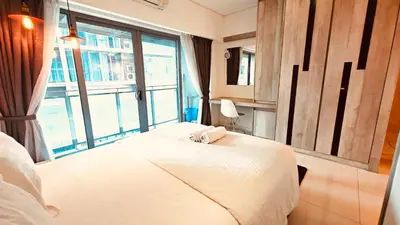 a bedroom with a bed and a large window at Mercu Summer Suites KL City Centre in Kuala Lumpur