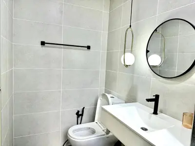 a bathroom with a white toilet and a mirror at The Elman new home in Setiawangsa in Kuala Lumpur