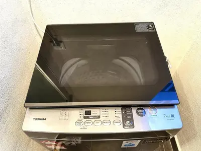 a laptop computer sitting on top of a device at The Elman new home in Setiawangsa in Kuala Lumpur
