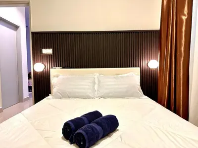 a bed with three blue towels on it at The Elman new home in Setiawangsa in Kuala Lumpur