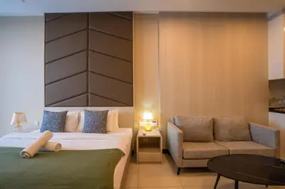 a hotel room with a bed and a chair at Societe by fafa in Kuala Lumpur