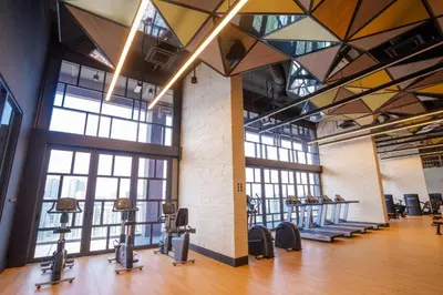 a gym with lots of windows and cardio machines at Societe by fafa in Kuala Lumpur