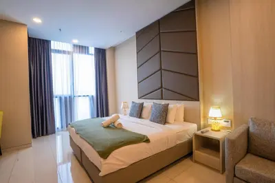 a bedroom with a bed with a stuffed animal on it at Societe by fafa in Kuala Lumpur