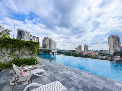 a view of a river with chairs and buildings at SIgnature Residence - Desa Sri Hartamas - Studio in Kuala Lumpur
