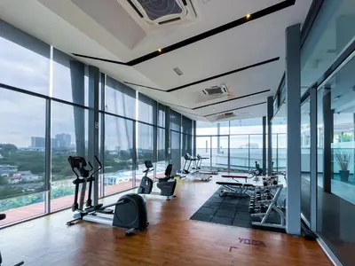 an office with large windows and a gym with exercise equipment at SIgnature Residence - Desa Sri Hartamas - Studio in Kuala Lumpur
