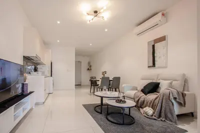 a living room with a couch and a tv at Quill Residences by DX in Kuala Lumpur