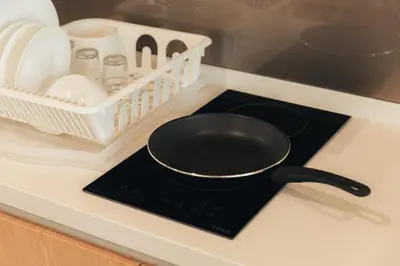 a frying pan sitting on top of a stove at Quill Residences by DX in Kuala Lumpur