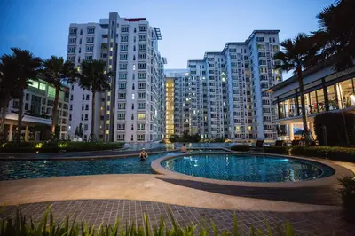 a pool in the middle of a city with tall buildings at Sunway Velocity Signature in Kuala Lumpur