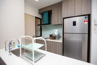 a kitchen with a refrigerator and a counter top at Sunway Velocity Signature in Kuala Lumpur