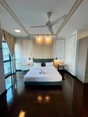 a bedroom with a white bed and a ceiling at Sunway Velocity Signature in Kuala Lumpur