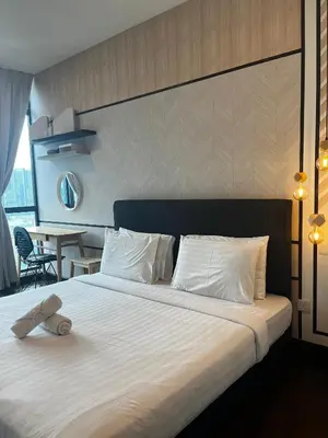 a bedroom with a large bed with a teddy bear on it at Sunway Velocity Signature in Kuala Lumpur