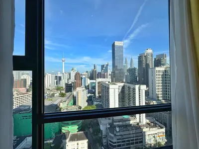 a view of a city skyline from a window at Axon Bukit Bintang Cozy 1BR Suite with KLCC View in Kuala Lumpur