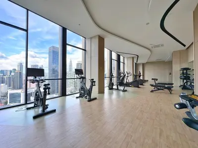 a gym with treadmills and exercise equipment in a building at Axon Bukit Bintang Cozy 1BR Suite with KLCC View in Kuala Lumpur