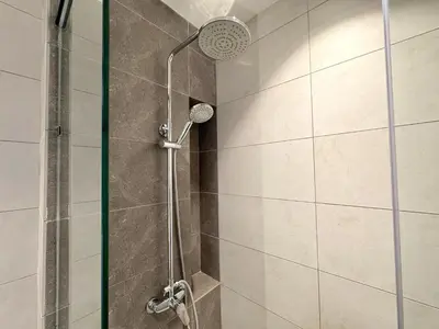a shower with a shower head in a bathroom at Axon Bukit Bintang Cozy 1BR Suite with KLCC View in Kuala Lumpur