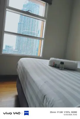a bedroom with a large bed with a large window at Sky Suites KLCC by KD SKY Family Suites in Kuala Lumpur