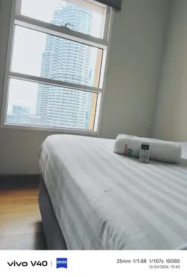 a large bed in a room with a large window at Sky Suites KLCC by KD SKY Family Suites in Kuala Lumpur