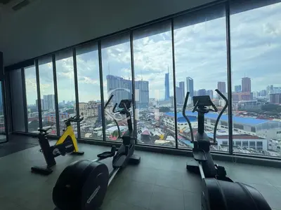 a gym with cardio machines in front of a large window at KL Cheras at The Continew 5 pax in Kuala Lumpur
