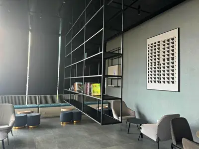 a waiting room with chairs and a book shelf at KL Cheras at The Continew 5 pax in Kuala Lumpur