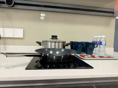 a pot sitting on top of a stove in a kitchen at The Atrium at Jalan Ampang by OKBnB - Modern 2Bedroom, 10 mins to Pavilion KL in Kuala Lumpur
