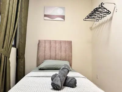 a bedroom with a bed with a headboard at Peaceful 3BR 2B with Pool 10pax Wangsa Maju near Wangsa Walk in Kuala Lumpur