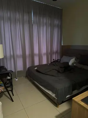 a bed sitting in a bedroom with a window at One Residences in Kuala Lumpur