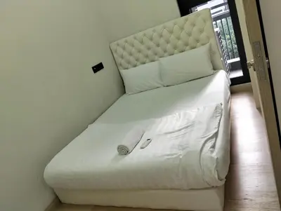 a white couch in the corner of a room at STAR Residences Popular By KLCC in Kuala Lumpur