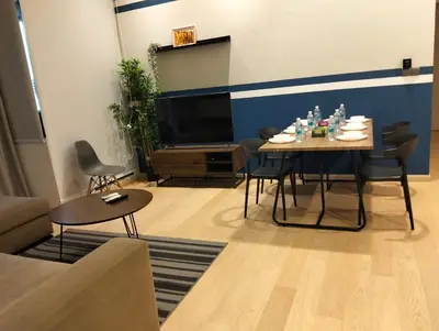a living room with a table and a tv at STAR Residences Popular By KLCC in Kuala Lumpur