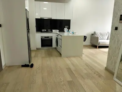 a kitchen with white appliances and a wooden floor at STAR Residences Popular By KLCC in Kuala Lumpur