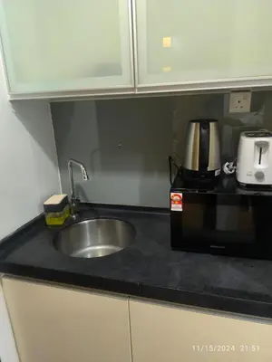 a kitchen counter with a sink and a microwave at 0186 Sweet Home-Casa Residency 1R 1B in Kuala Lumpur