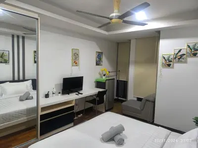 a bedroom with a bed and a desk with a computer at 0186 Sweet Home-Casa Residency 1R 1B in Kuala Lumpur