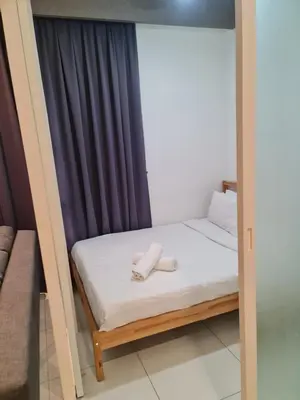 a room with a bed with two towels on it at ROBERTSON RESIDENCE south SUITES IN KUALA LUMPUR in Kuala Lumpur
