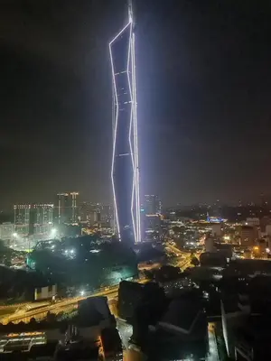 a tall building with lights on it at night at ROBERTSON RESIDENCE south SUITES IN KUALA LUMPUR in Kuala Lumpur