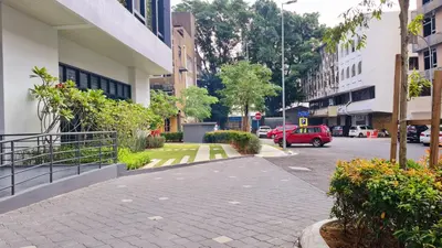 a street in a city with a red car on the road at Chambers Suites KL By 969 in Kuala Lumpur